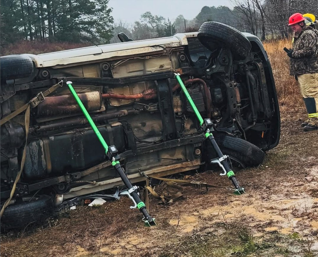2 Mighty Struts stabilizing the bottom of a small SUV rolled onto its side using 10 inch extensions, 30 inch extensions and combo heads. 