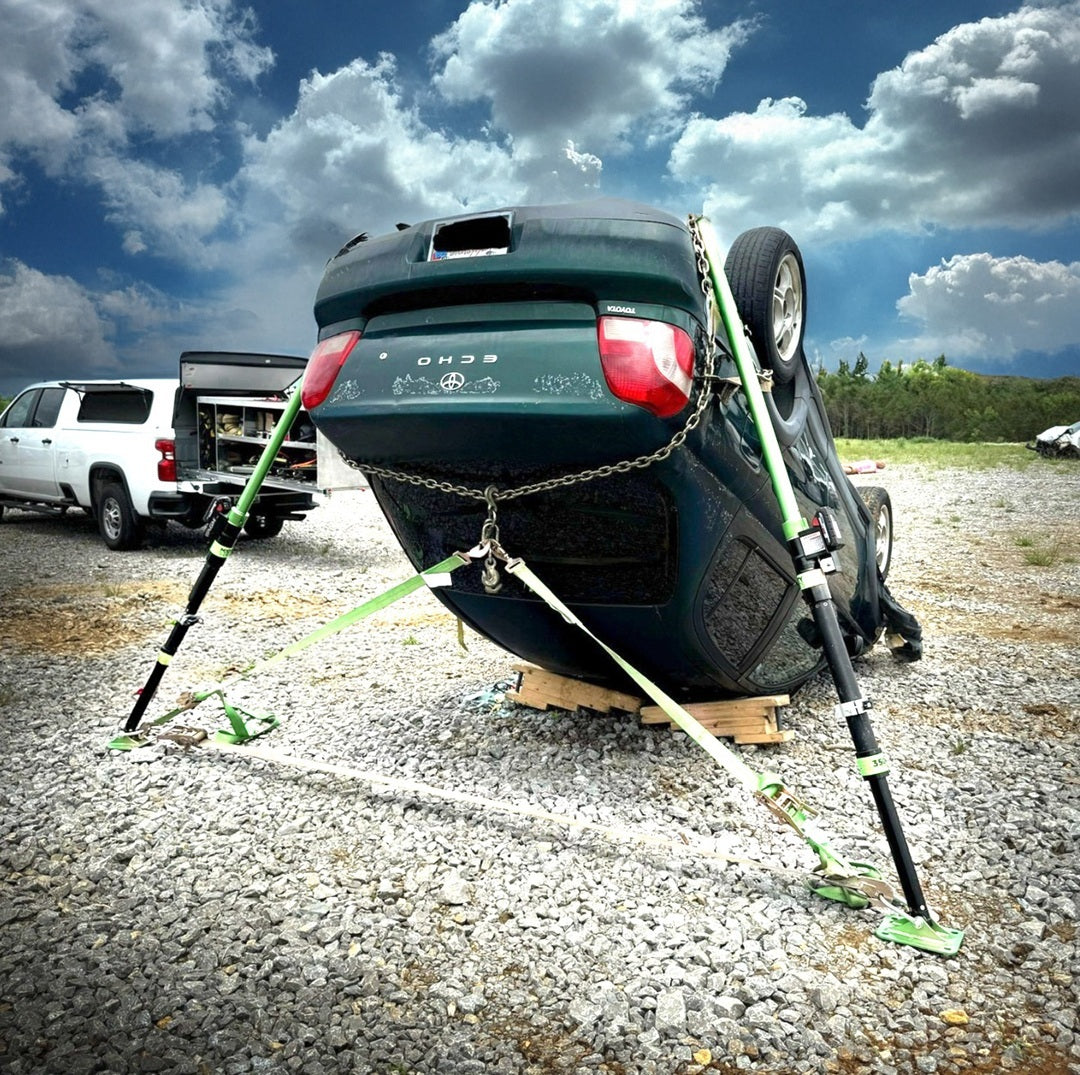 Mighty Struts stabilizing the back of an upside down car using a chain sling. 